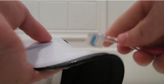 cleaning a white baseball hat