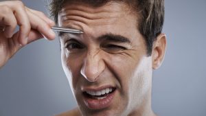 trim men's eyebrows with beard trimmer